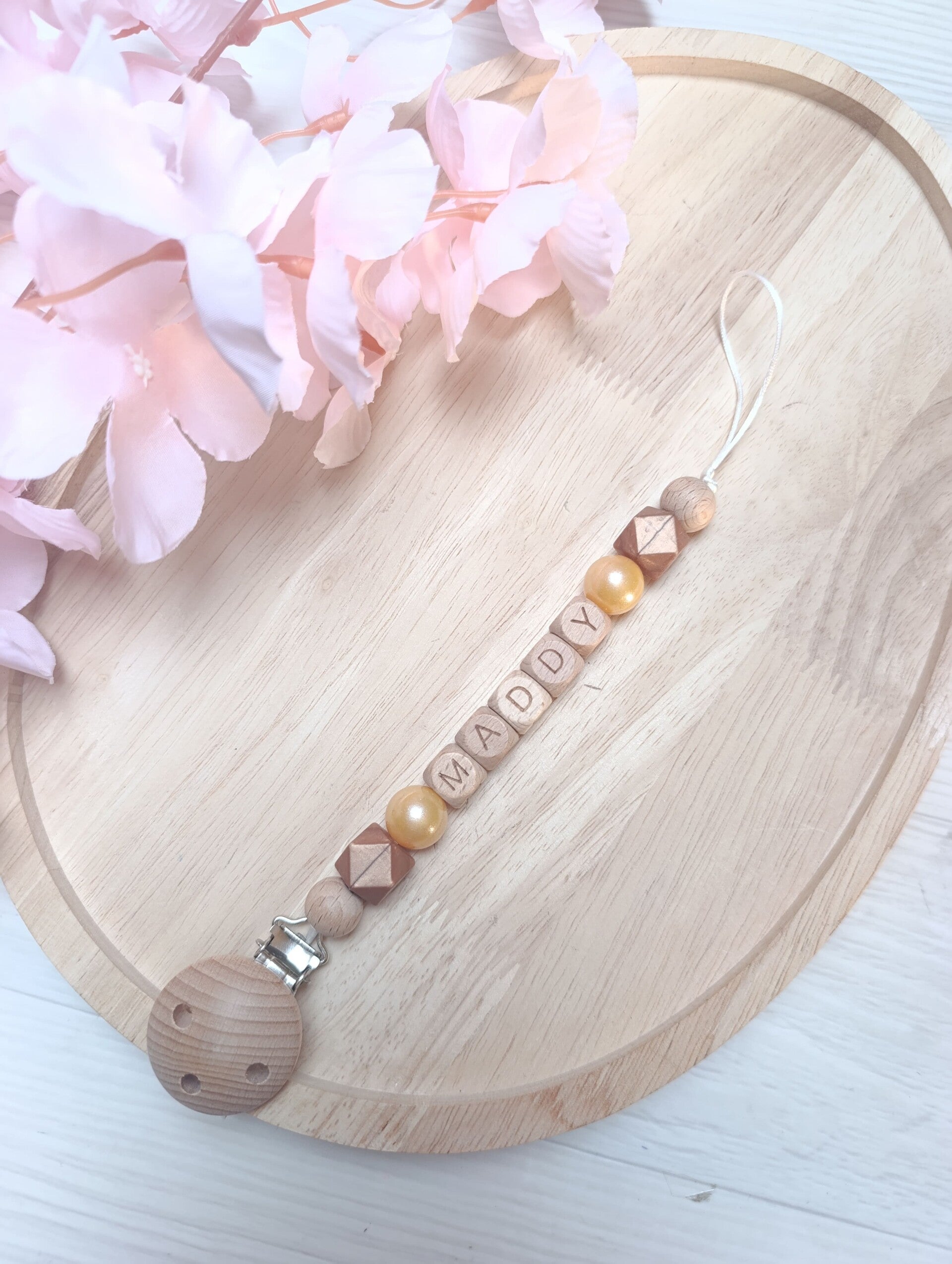 Attache tétine or bronze