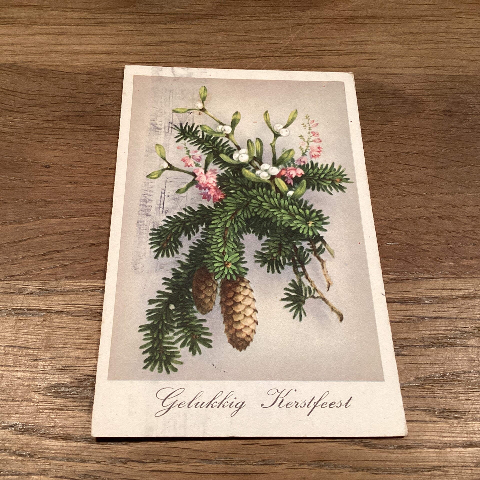 Antieke kerstkaart mistletoe, dennentakken en appels, uit 1942
