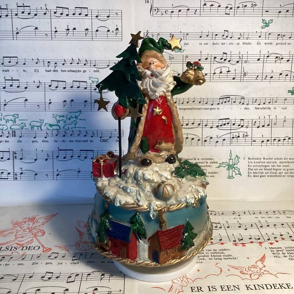 Fraai muziek carrousel merry christmas kerstman op voet