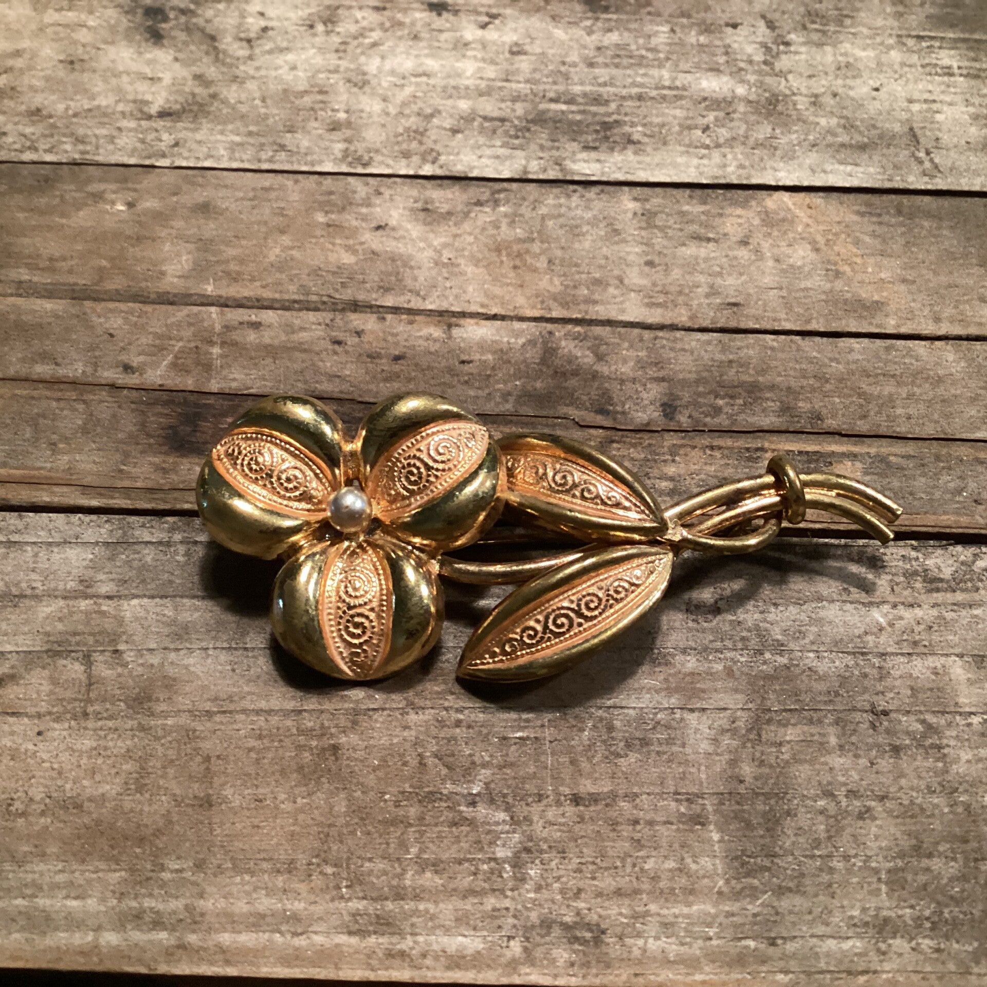 Goudkleurige bloemenbroche met pareltje, 6x2,5 cm