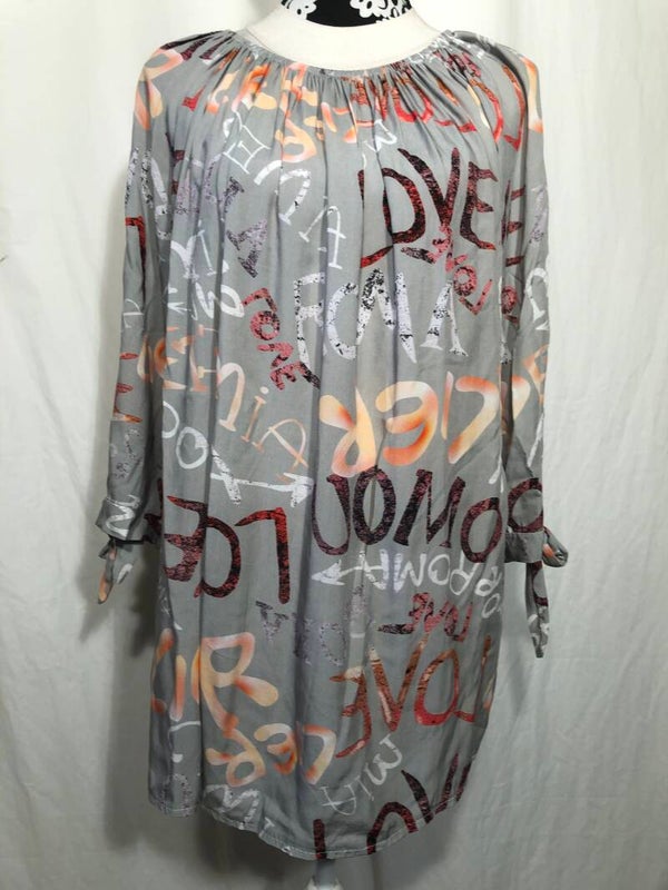 Lichtgroen tuniek met letters maat XL