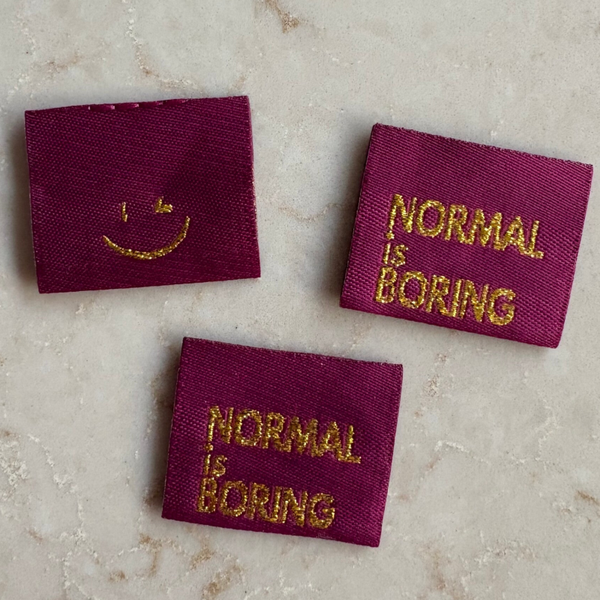 Label 'Normal is Boring' - bordeaux