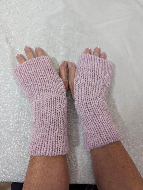 Baby pink pair of knitted hand warmers
