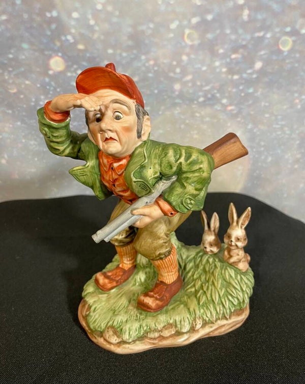 Vintage Mid-20th Century Hand-Painted Porcelain Figurine – The Bewildered Hunter with Rabbits