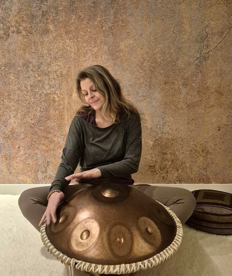 Foto van Sandra Groenewoud yogadocent van Je Zachtkracht. Ze speelt op de drum. 