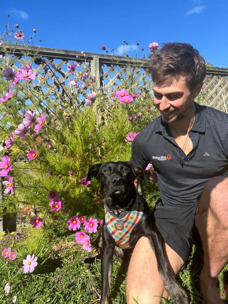 Reignite Physio's physio with his dog Ardie at his home in the garden. 