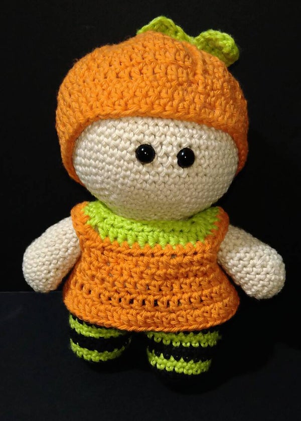 Doll in pumpkin dress