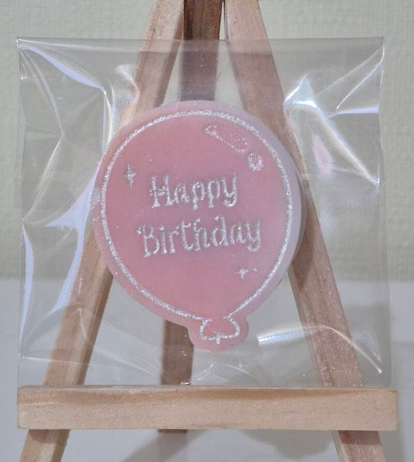 Happy birthday balloon in snow angel