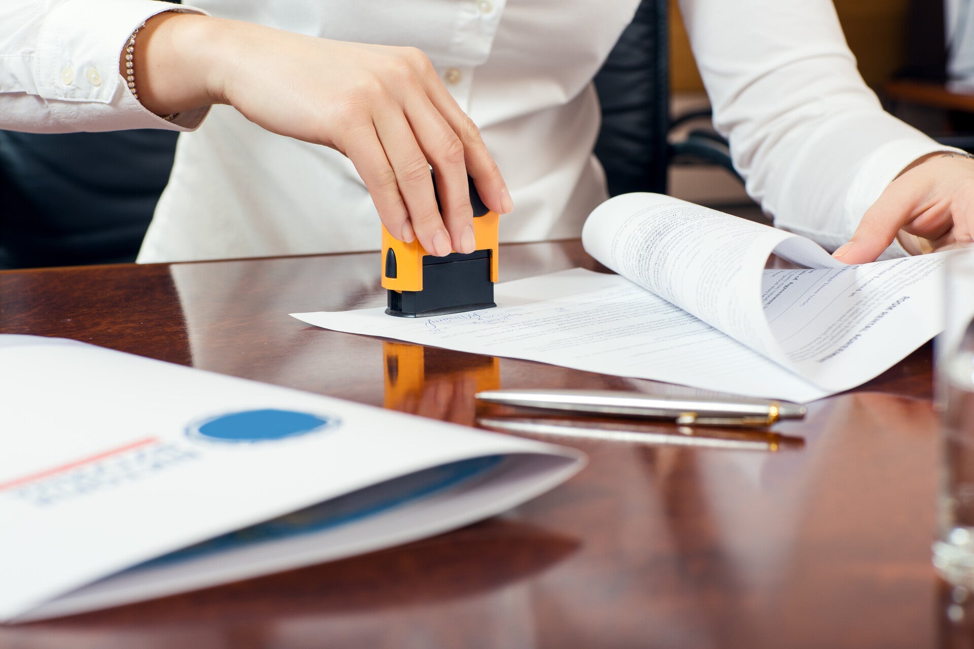 Image of notary stamping documents.