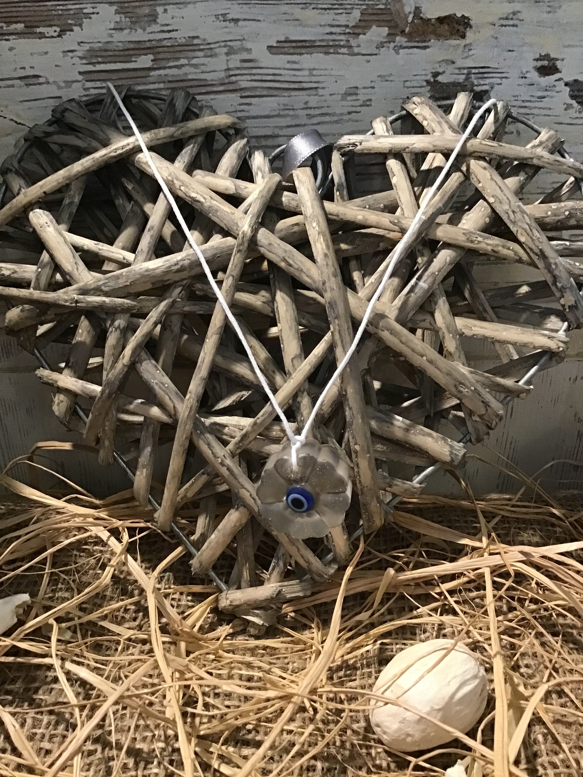 Collier médaillon fleur et œil de protection