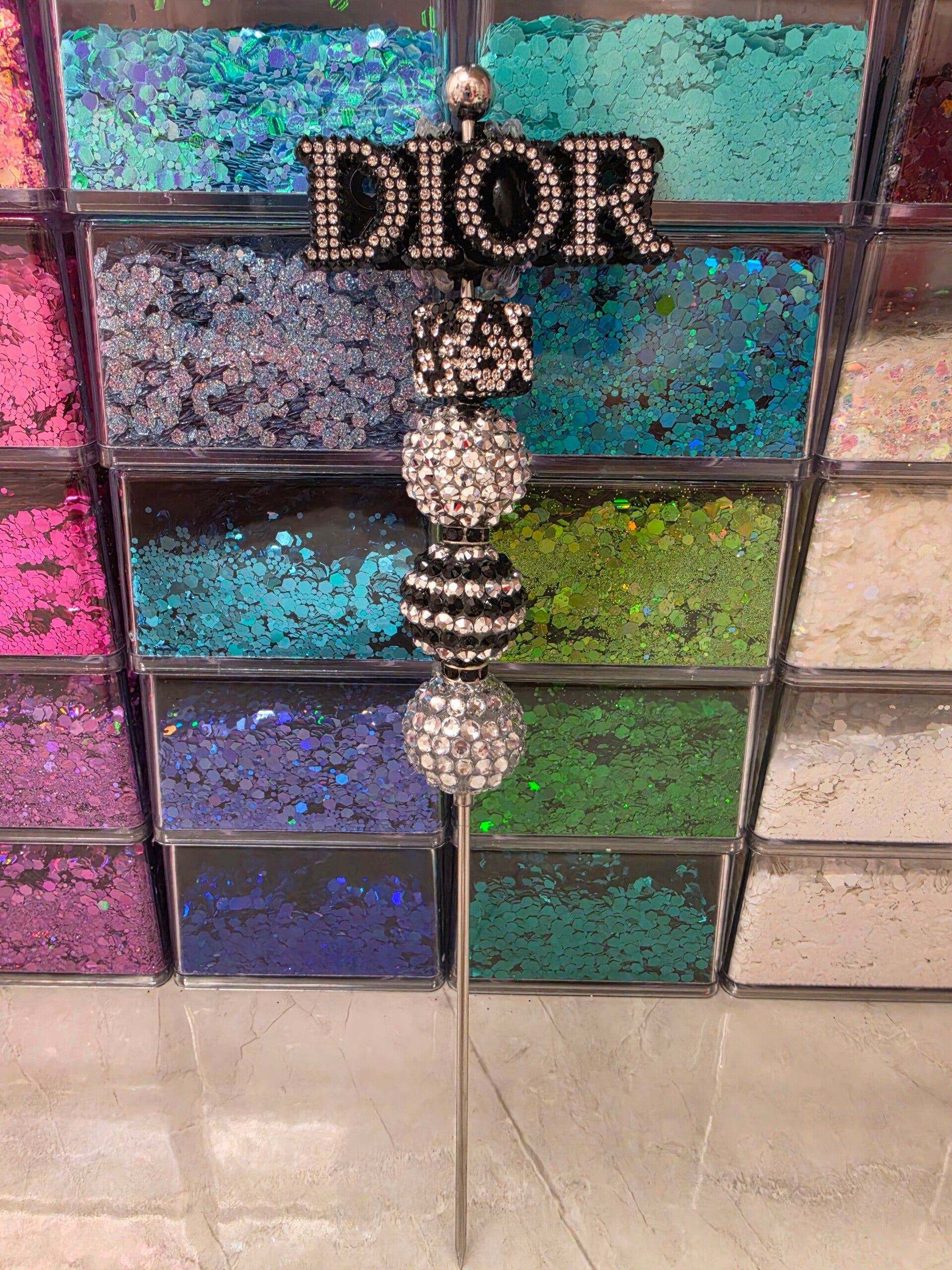 Black and silver Dior pokey tool