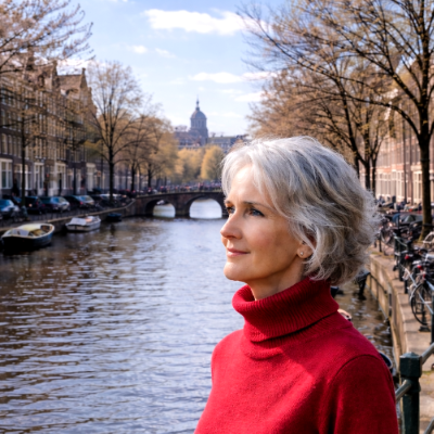 photo of Maya Frost, creator of Collapse Companioning,  standing by a canal in Amsterdam, The Netherlands.