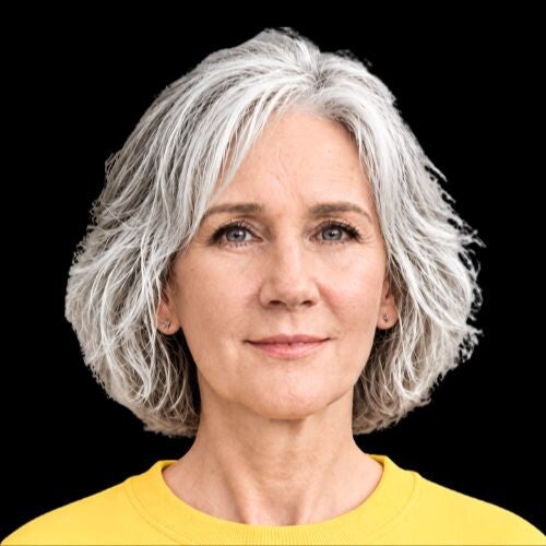 MAya Frost, creator of Lucid Longing, wearing a white turtleneck sweater against a bright yellow background.. Founder of Collapse Forward. Futurist, practitioner, researcher on longing.