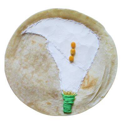 photo of art by Maya Frost, creative adaptation and personal resilience expert, a round flour tortilla embroidered with white stitching, white flour, and green and yellow accents to create a calla lily.