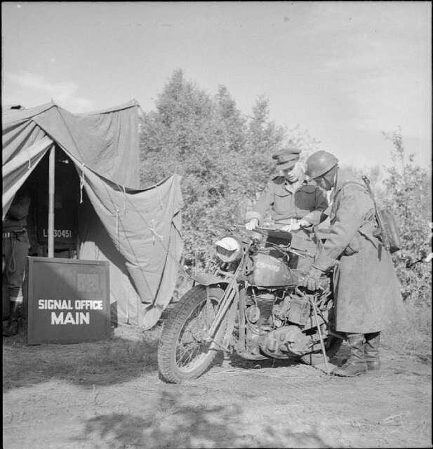 Royal Signals dispatch rider outside a signal office in North-West Europe during the Second World War
