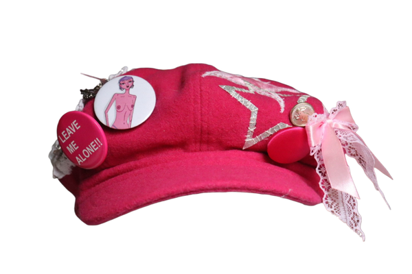 Pink newsboy cap with patches and buttons