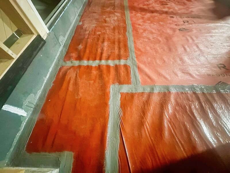 The Radon membrane has been installed and joint to the Triotherm door upstand by having the junction secured with a tape and a complete tanking over afterwards.wards.