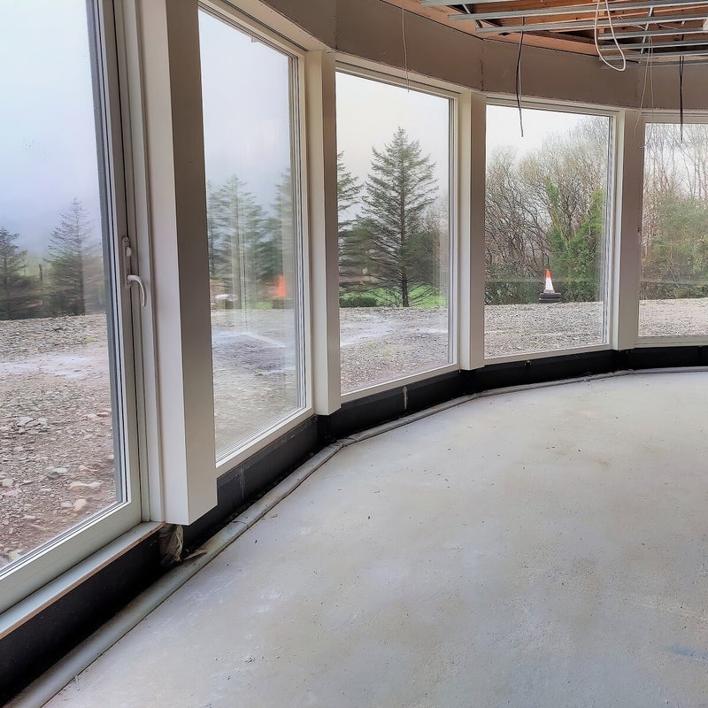 Triotherm door upstand for a curved architectural glazing.