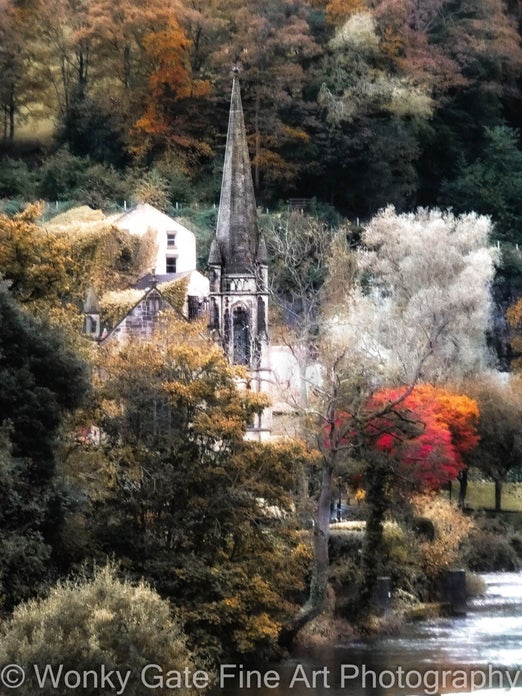 Photograph of Llangollen Methodist Church rising out of auturm trees on the bank of the River Dee.