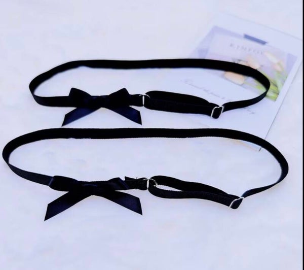 One pair of black garters with bow