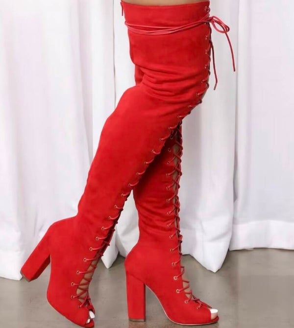 Luxurious thigh-high lace-up boots in bold fiery red suede.