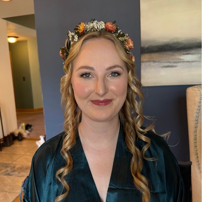 Bride and groom embracing outdoors during a Colorado mountain wedding, showcasing romantic bridal beauty and a glowing skin-focused makeup look in Black Hawk, Colorado.