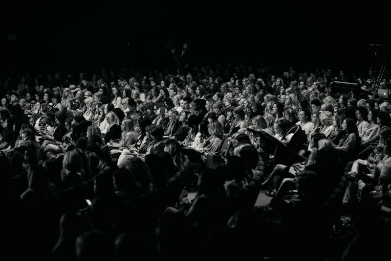 Corporate conference audience attending a professionally managed live event.