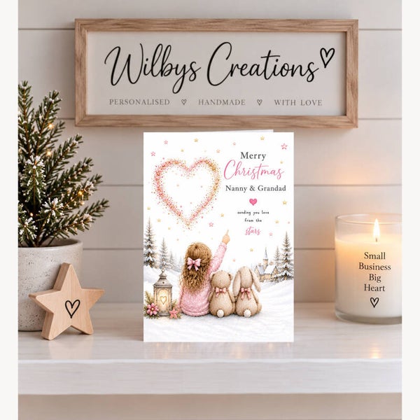 Merry Christmas Nanny & Grandad – Little Girl, Teddy & Bunny Beneath a Heart of Stars Card