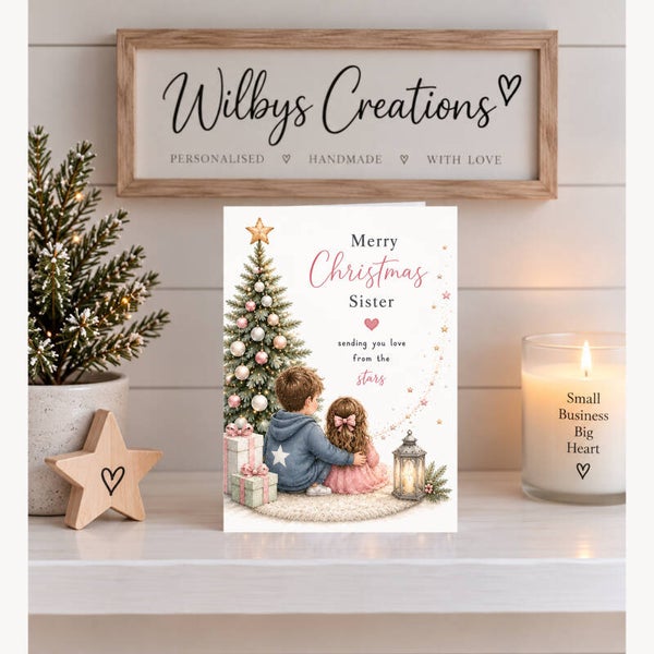 Merry Christmas Sister – Brother & Sister Beside a Christmas Tree with Pink Baubles Card
