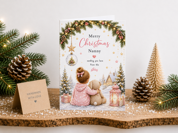Merry Christmas Nanny Card – Girl and Teddy by Snowy Cottage
