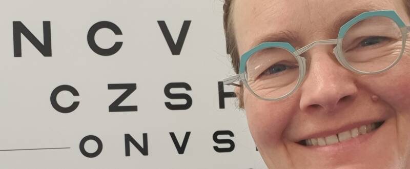 Cirta posing in front of LogMAR chart