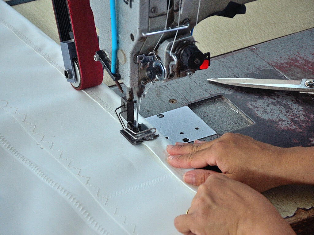 Jachtzeil maken met naaimachine op zeilmakerij