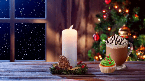 Agif image scene of christmas candle and coffee drink in a window sill of snow