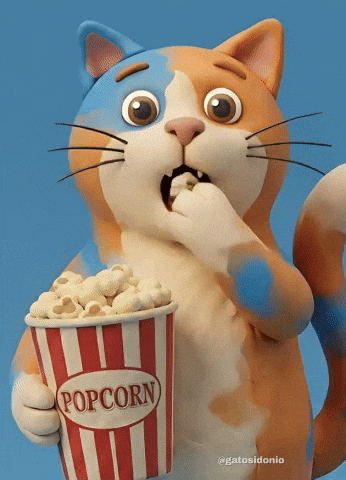  Animated cat with orange, white, and blue fur eating popcorn from a red‑and‑white striped tub marked “POPCORN,” against a light‑blue background.