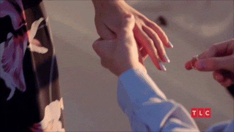 “A wedding ring being placed on a finger, symbolising love and commitment.”