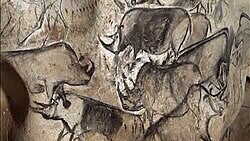 “Prehistoric cave art featuring early human drawings on rock walls.”