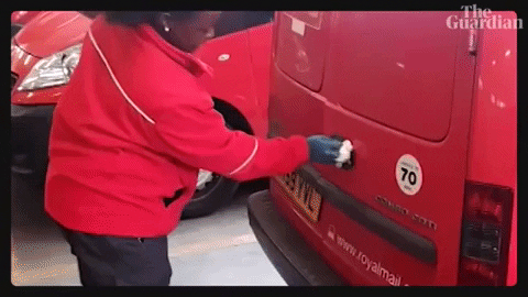“Royal Mail postal worker locking the van and walking to the driver’s seat, symbolising card deliveries leaving the studio.”
