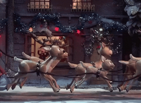 A animated gif of santa and sleigh passing a christmas house