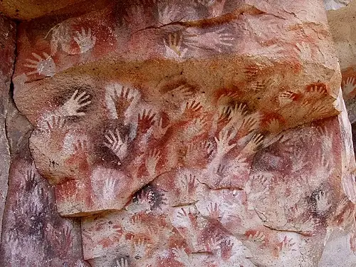 “Ancient cave painting showing animals created with natural pigments.”