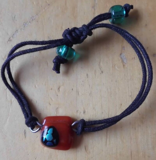 Zwarte armband met oranje hanger 55197r