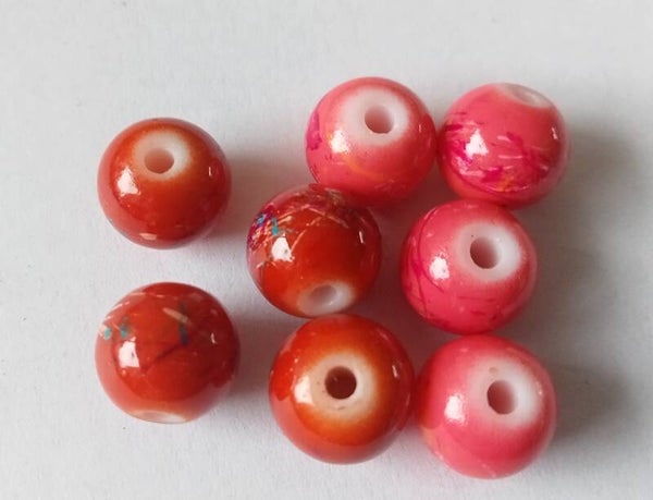 Glaskralen oranjerood of roze met gekleurde streepjes 10 mm 90971 Ua