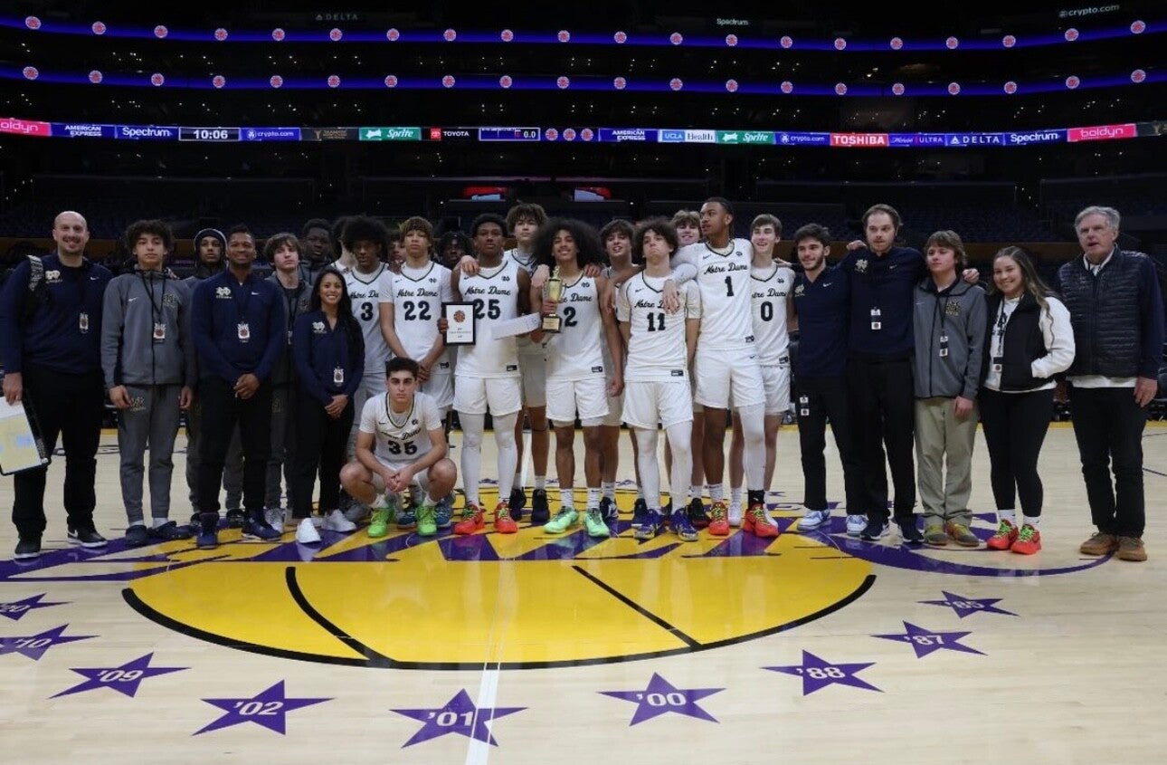 Boys varsity basketball team and staff on half court at Lakers stadium after winning the Souther Section championship. 