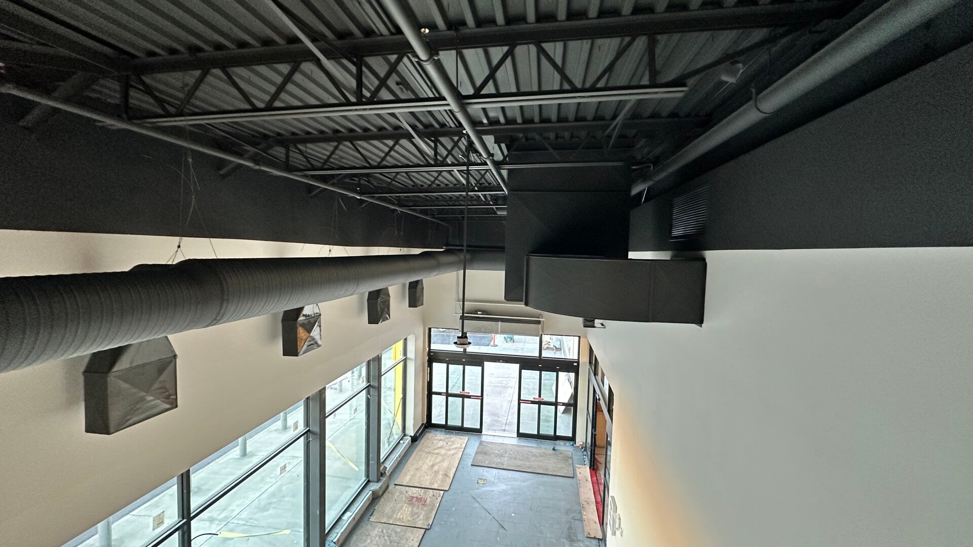 Commercial space with a dark painted ceiling and white walls