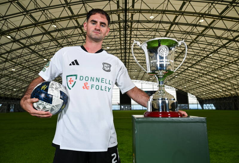 FAI Official Launch event on the 25th Aug 2026 - Gareth Doherty from Lettereknny Rovers pictured alongside the new FAI National League Trophy