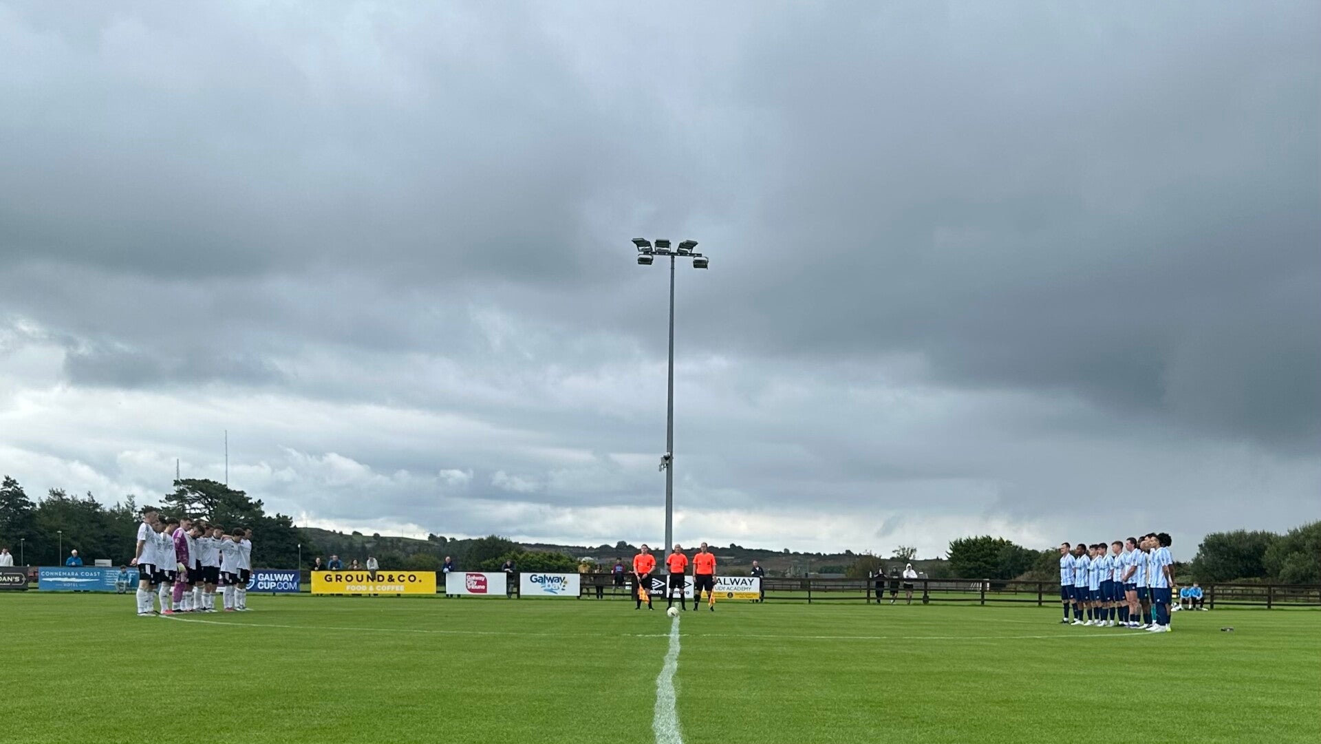Letterkenny Rovers and Salthill Devon observe a moments silence in honour of Ollie Horgan on the first anniversary of his death.