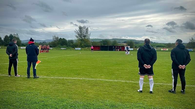 Players observe a minute silence in advance of the game.