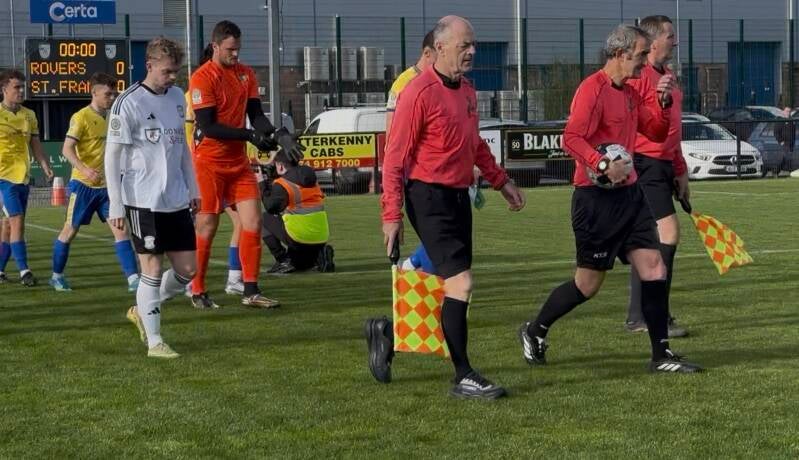 Teams being led to the pitch by referee and assistants for Letterkenny Rovers v St. Francis on the 10th October 2026