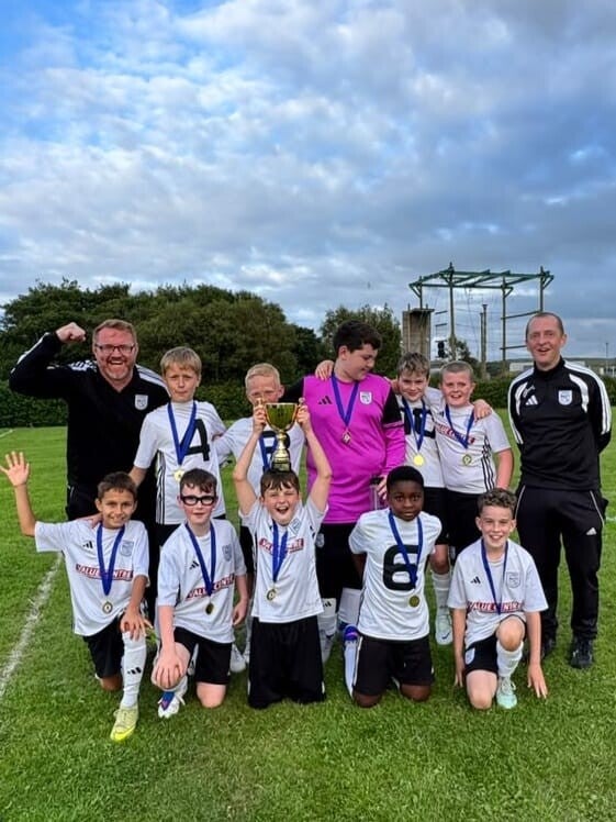 U12 Athletic team photo celebrating their shield win at the Kenny Woods Memorial Tournament in Bushmills on 15th August 2026