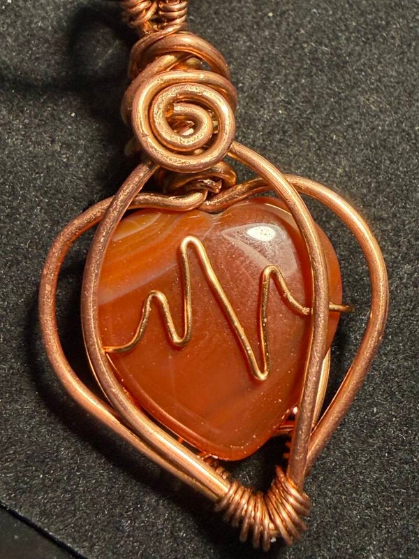 Carnelian crystal heart wrapped with copper. Heart rhythm pendant