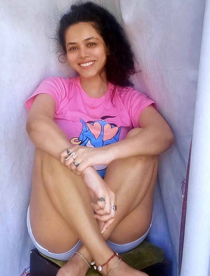 Vaishnavi Dhanraj hot thigh show by sitting legs up on a stool